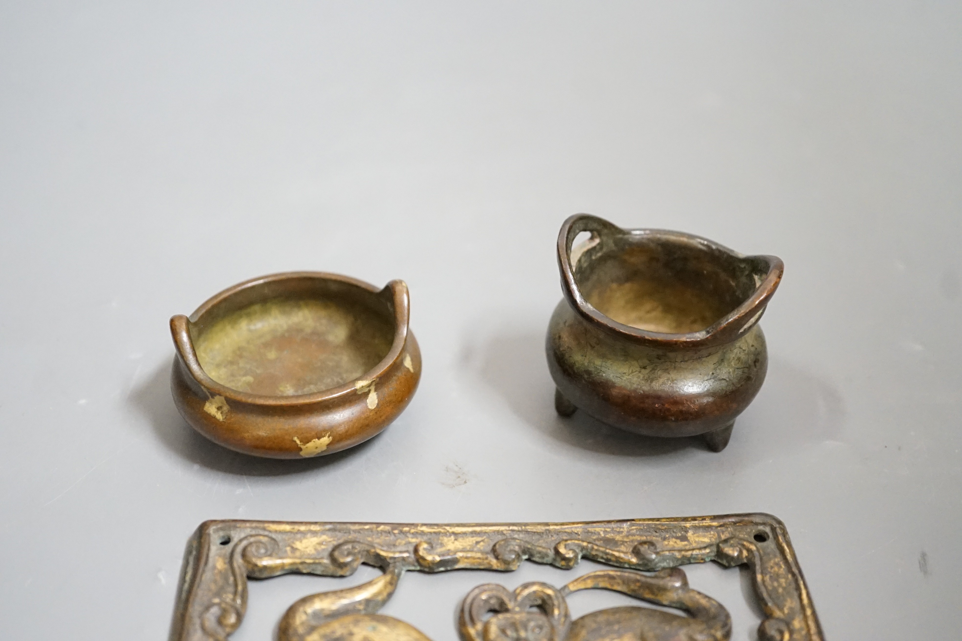 Two small bronze two handled censers and an Ordos style pierced bronze monkey panel, 13cms wide